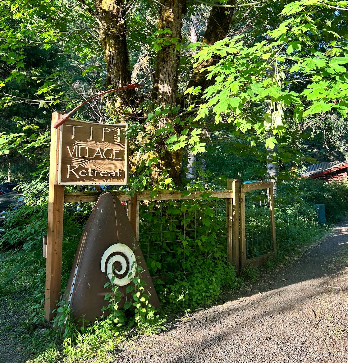 Carved spiral trail sign at Tipi Village