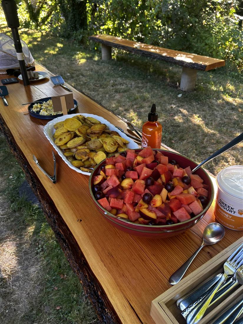Fresh outdoor meal spread by the creek