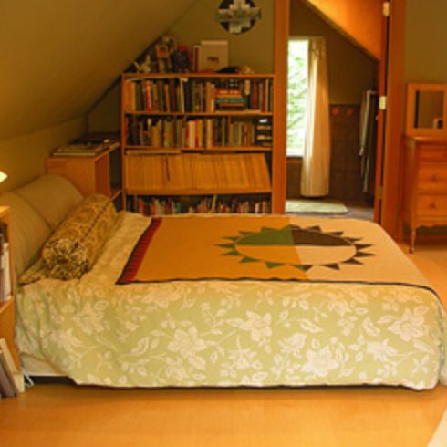 Cabin bedroom with a cozy bed and bookshelf